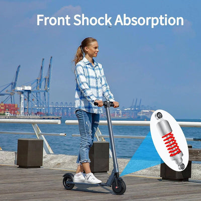 Electric scooter image showing front shock with hub motor and sleek frame while ridden across a pier, 250W scooter